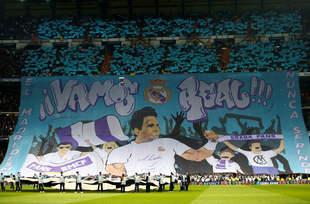 Real Madrid fans hold up a banner displaying an image of Rafael Nadal.