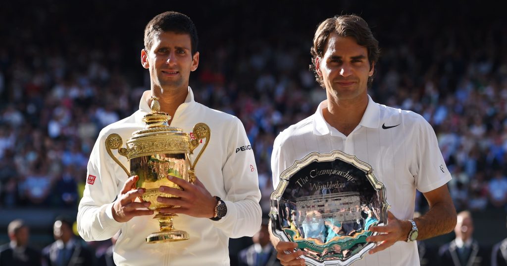 Djokovic and Federer pose with their trophies in Wimbledon in 2014