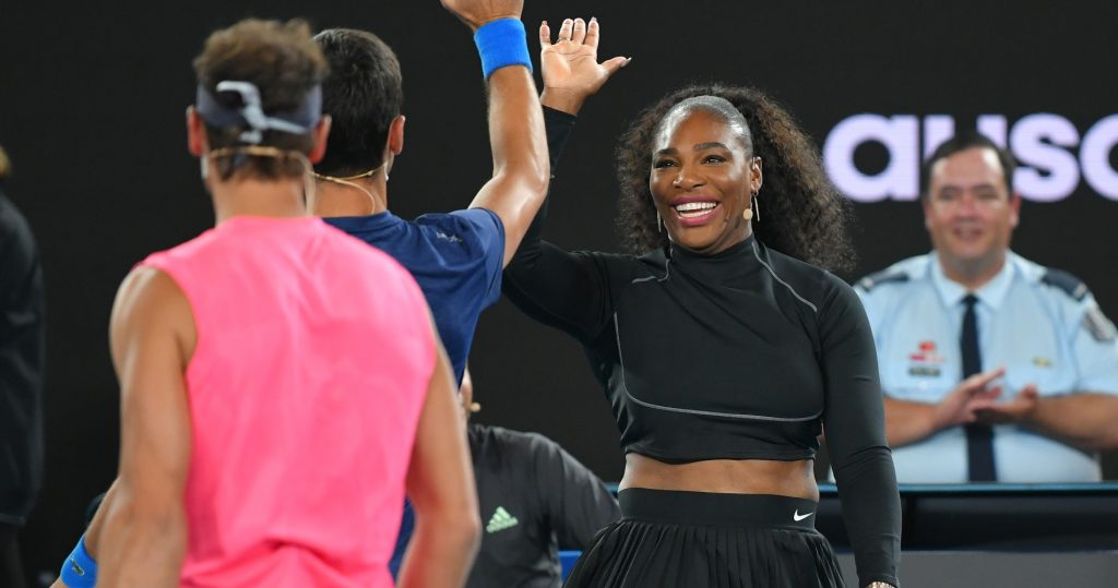 Serena Williams clapping hands with Novak Djokovic at a charity event before the 2020 Australian Open