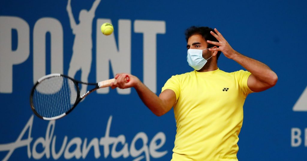 Hassan wearing a mask during warm-up at Exo Tennis.