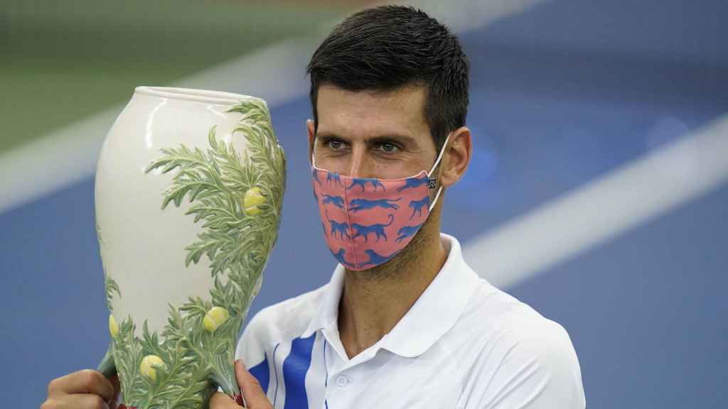 Novak Djokovic holds his winning trophy after winning final with Milos Raonic, Western and Southern Open, August 2020
