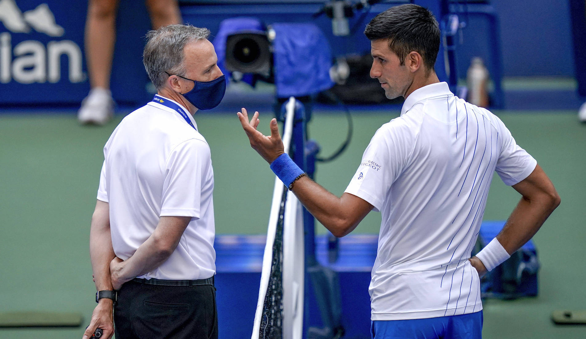 Novak Djokovic, of Serbia, talks with the umpire after inadvertently hitting a line judge with a ball after hitting it in reaction to losing a point against Pablo Carreno Busta, of Spain, during the fourth round of the US Open tennis championships, Sunday, Sept. 6, 2020, in New York. Djokovic defaulted the match. (AP Photo/Seth Wenig)/USO169/20250742484133//2009062231