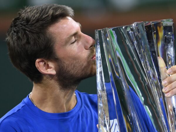 Cameron Norrie (GBR) holds the championship trophy after defeating Nikoloz Basilashvili (GEO) in the men's final in the BNP Paribas Open at the Indian Wells Tennis Garden.