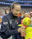 Chinese tennis player Peng Shuai signs large-sized tennis balls at the opening ceremony of Fila Kids Junior Tennis Challenger Final in Beijing, China November 21, 2021