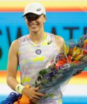 Iga Swiatek (POL) is presented a bouquet for becoming the number one women's player in the world after her victory over Victorija Golubic (SUI) (not pictured) in a second round women's singles match in the Miami Open at Hard Rock Stadium.