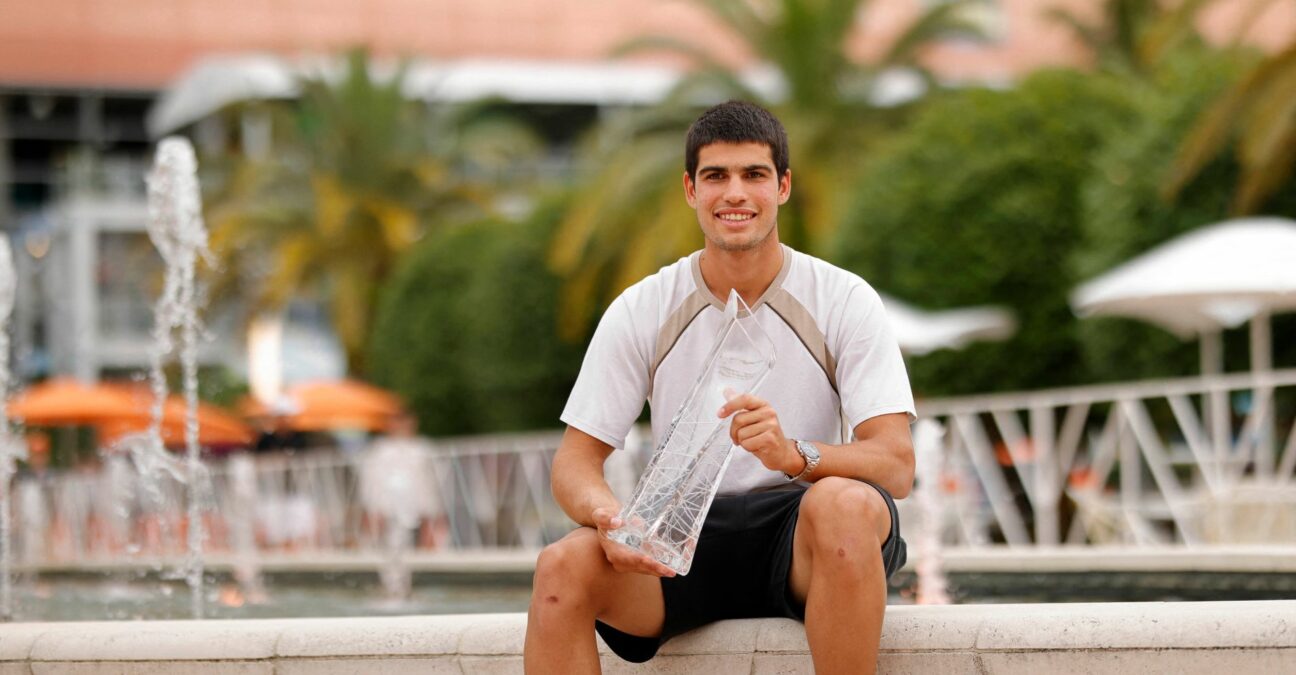Carlos Alcaraz poses for a portrait while holding the Butch Buchholz Championship Trophy after winning the men's singles final in the Miami Open at Hard Rock Stadium.