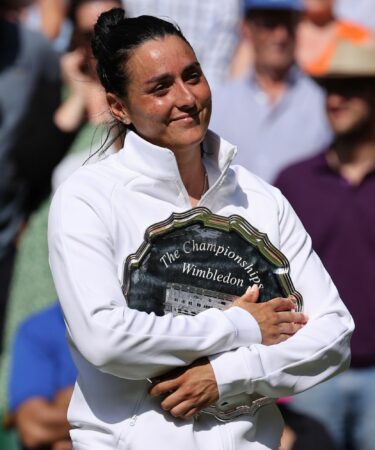 Ons Jabeur (TUN) poses with the runners up plate at the Wimbledon Championships